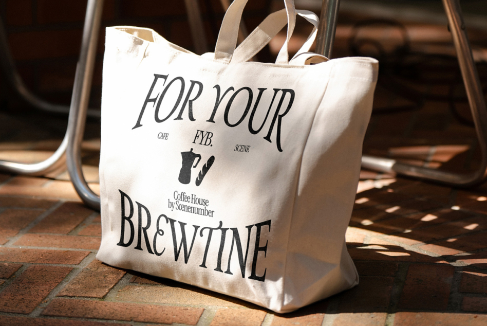 Cream canvas tote bag with For Your Brewtine text on brick outdoor patio