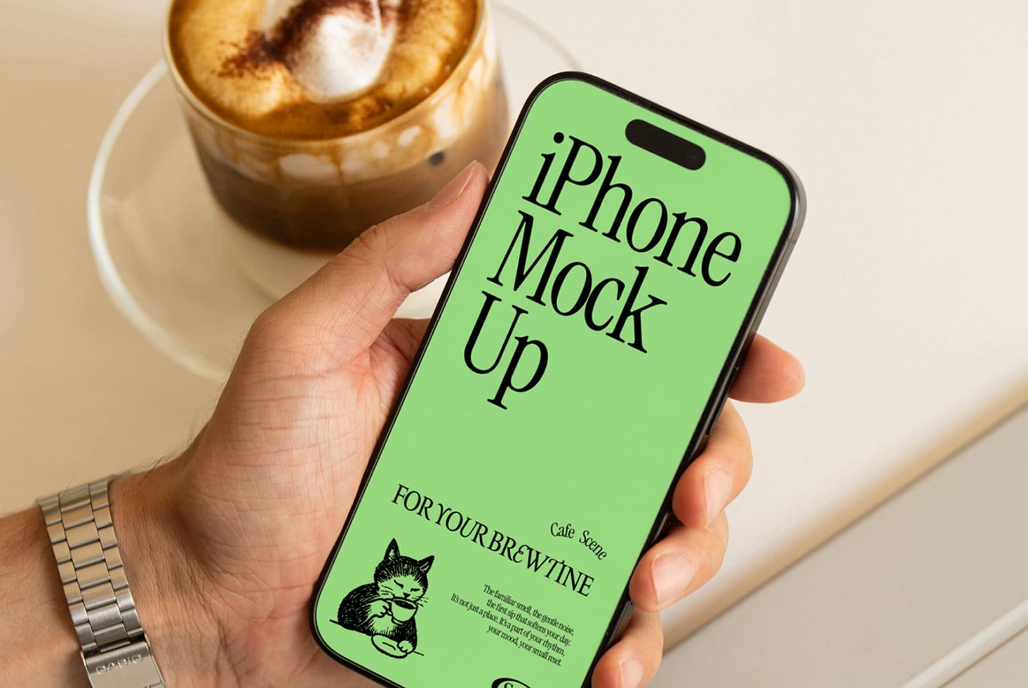 iPhone 14 Pro mockup with neon green screen next to coffee cup on table