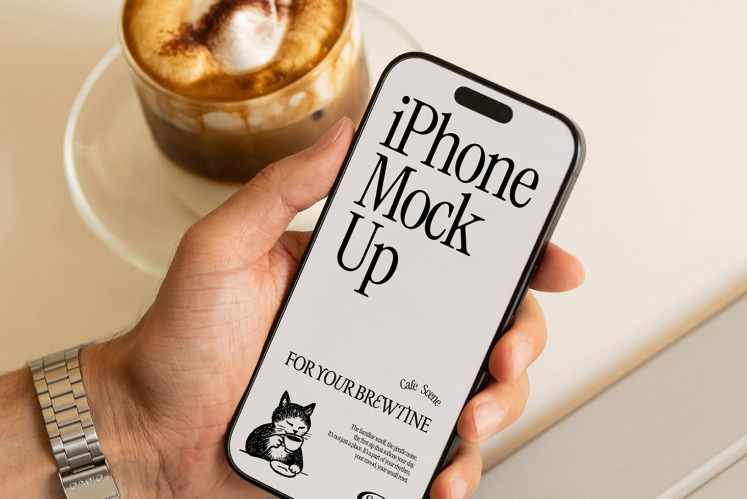 iPhone 14 Pro mockup with cafe branding, holding phone next to iced coffee drink
