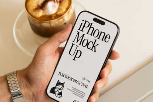 iPhone 14 Pro mockup with cafe branding, holding phone next to iced coffee drink