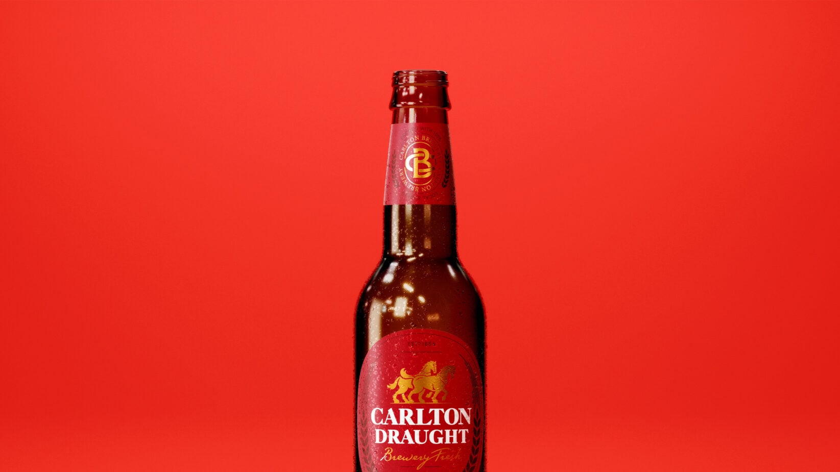 Carlton Draught beer bottle shot against bright red background