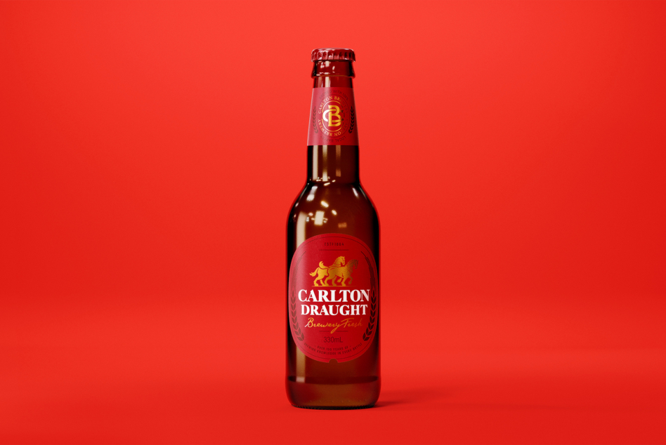 Full Carlton Draught beer bottle on red background studio lighting
