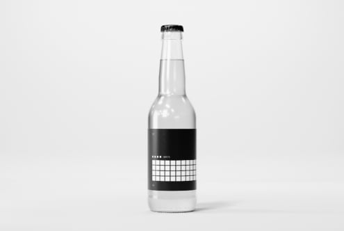 Clear glass beer bottle with black label mockup on white background
