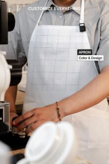 Cook wearing white apron with grid pattern mockup for editable branding
