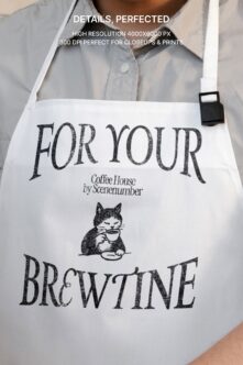 Close up of white apron showing For Your Brewtine design with cat holding cup
