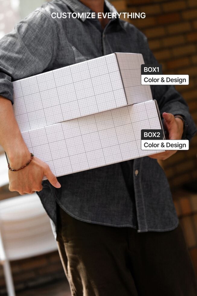 Grid paper boxes held by person in denim shirt showing customizable packaging design