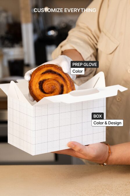 Customizable pastry box mockup with white gloves holding cinnamon roll, editable layers