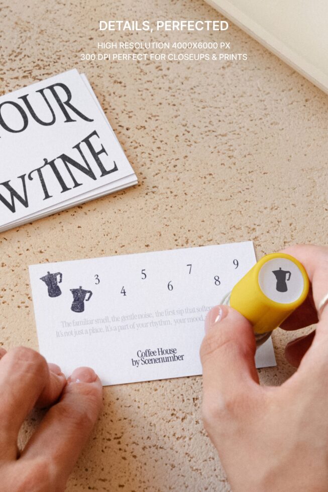 Close-up of yellow punch stamp stamping loyalty card with coffee pot icons