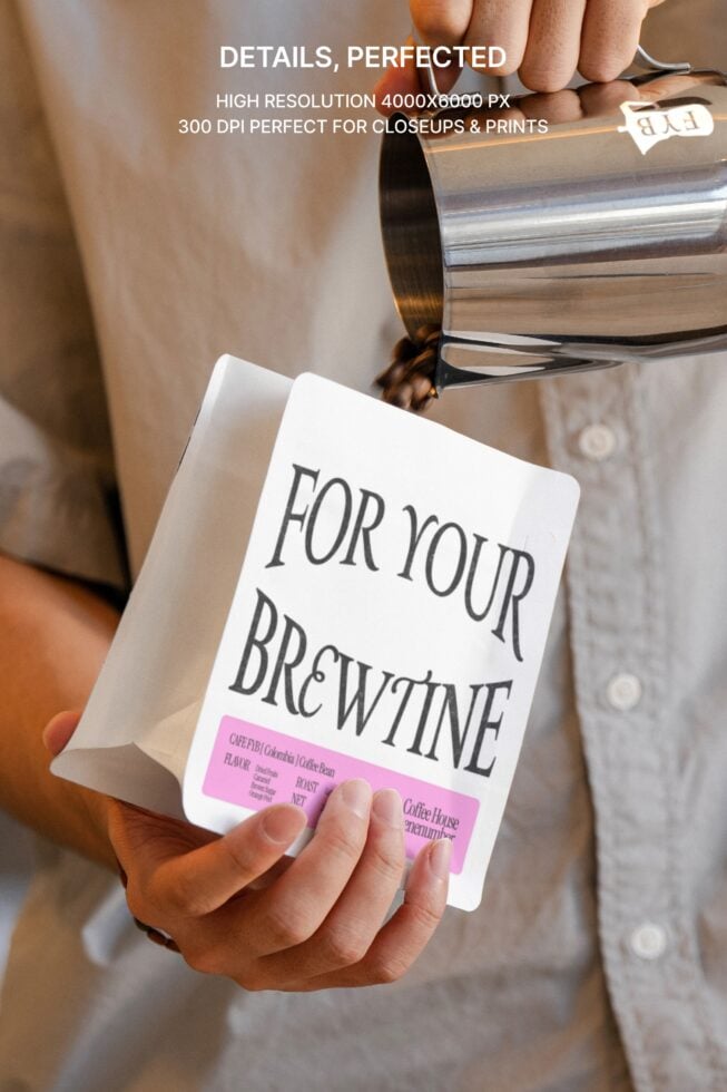 Close up of hands pouring milk over coffee bag mockup with pink label detail