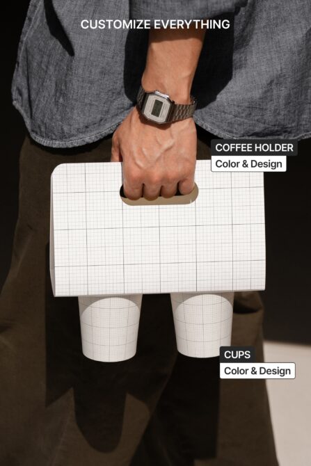 Close-up of hands holding grid coffee holder with two white cups, design mockup view
