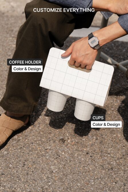 Person holding grid coffee holder with two branded cups below, ready to edit colors