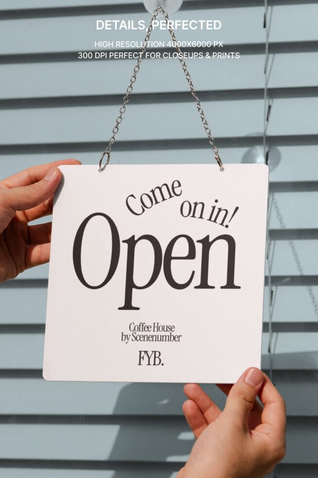 Hand holding pale pink sign saying Come on in Open with chain attached