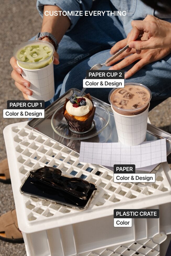 Close up hands holding green drink, chocolate dessert on tray with customizable cups