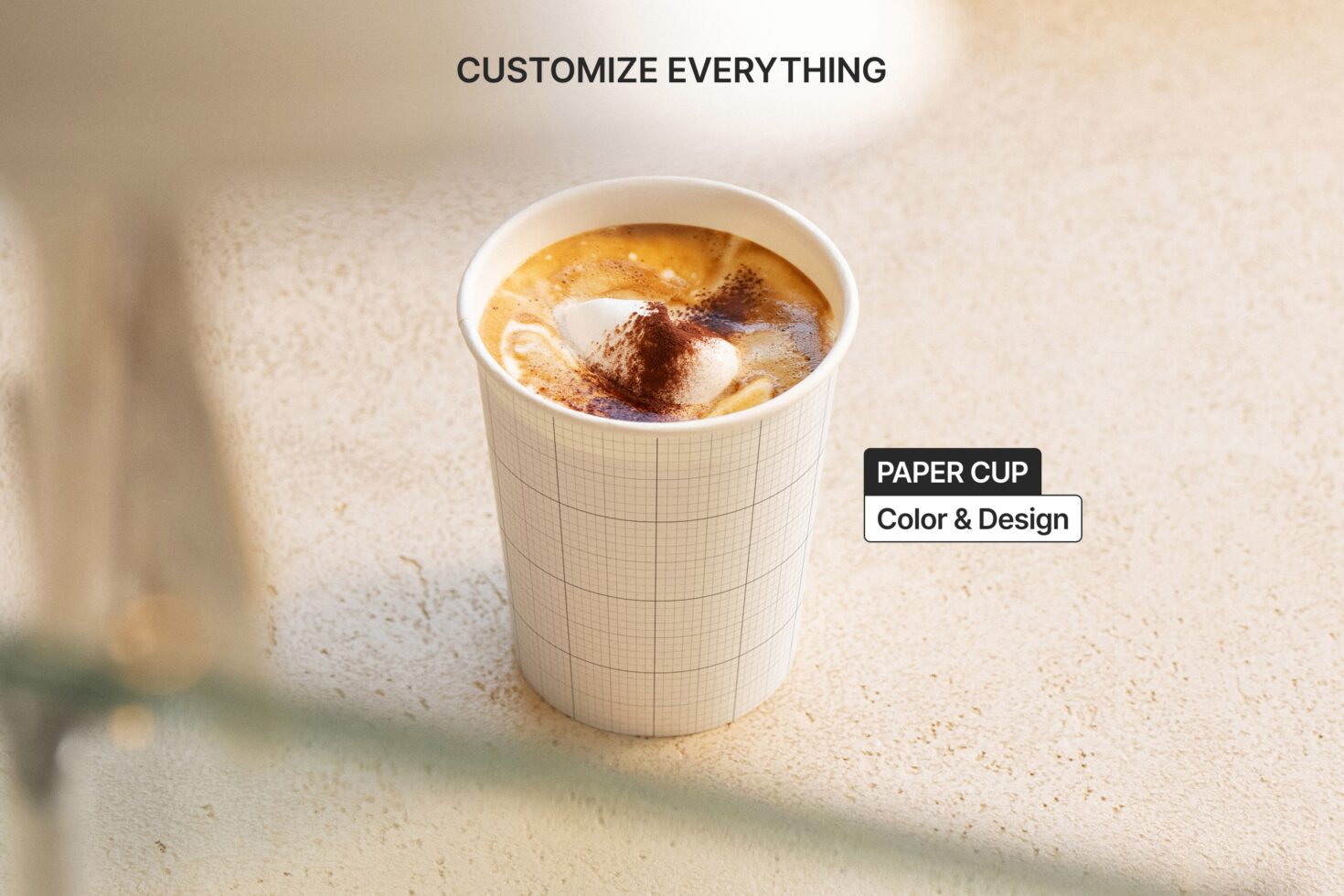 Single hot beverage cup with grid pattern sleeve, latte art topped with cinnamon
