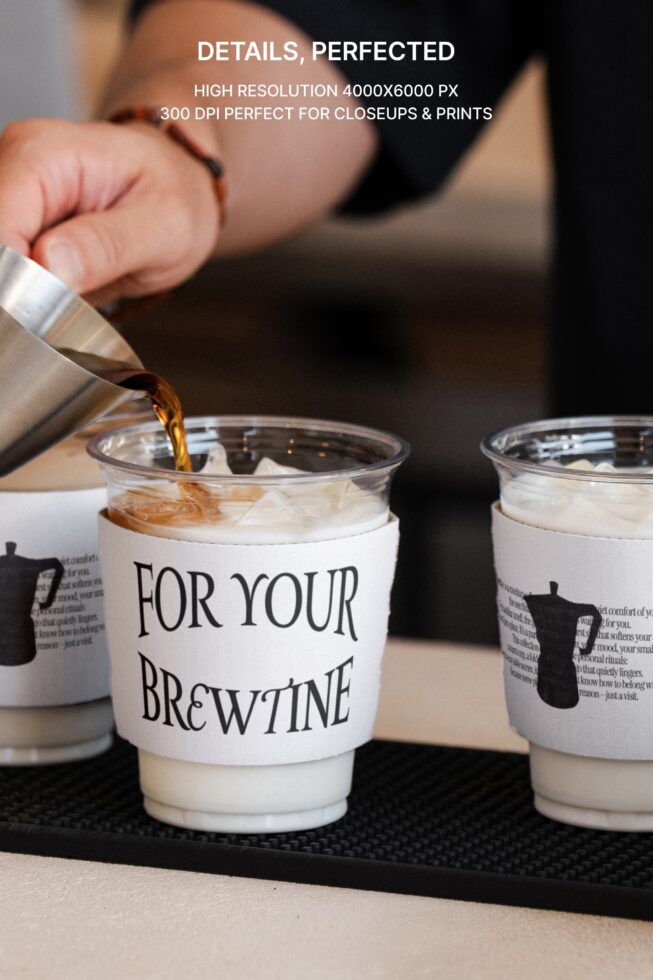 Close-up of iced beverage in labeled cup with espresso pour action
