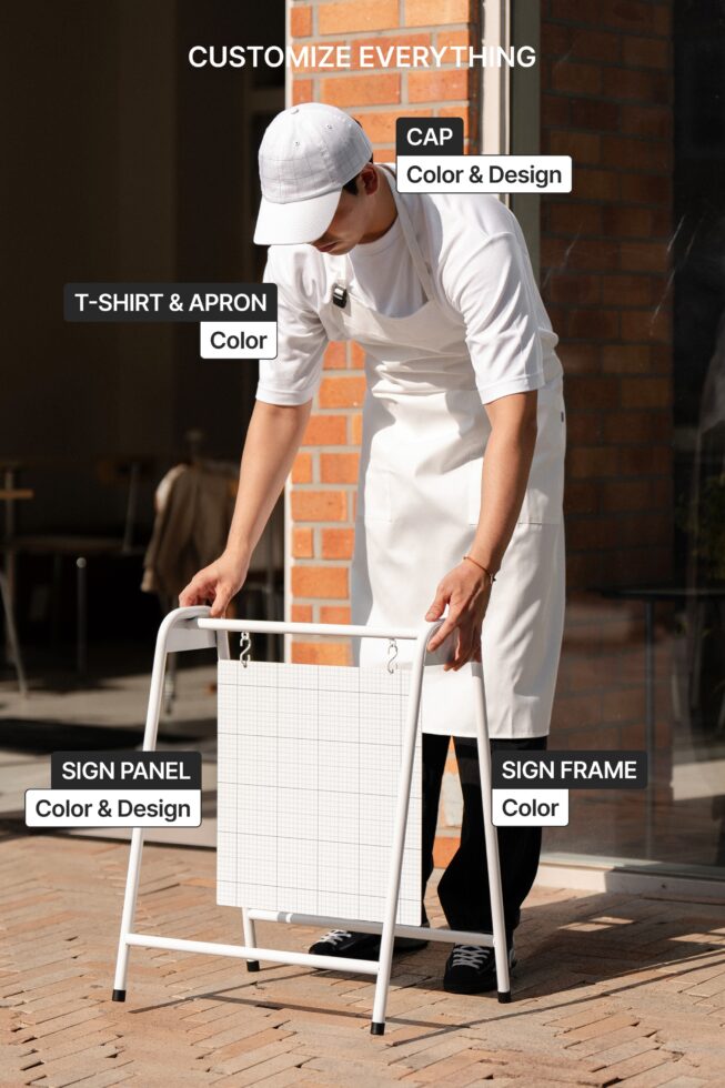 Worker in white apron, cap, tee holding blank A-frame sign with customizable panels