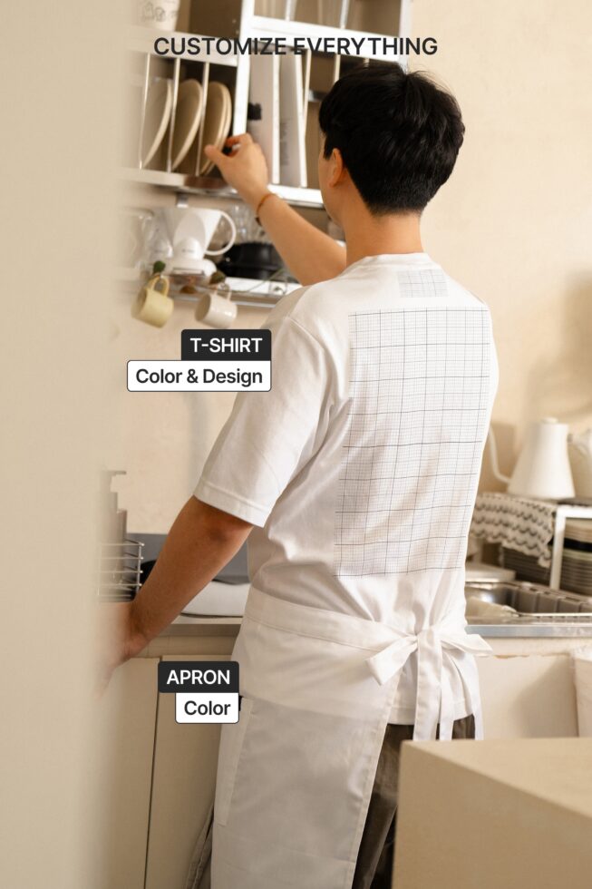 Person from behind wearing white tee with grid pattern mockup on kitchen cabinet
