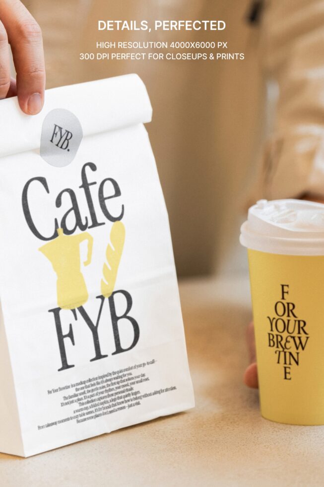 White paper bag with yellow coffee cup graphic, sticker, cup mockup in outdoor setting