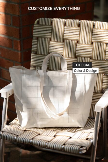 Blank white tote bag on striped chair with brick wall behind