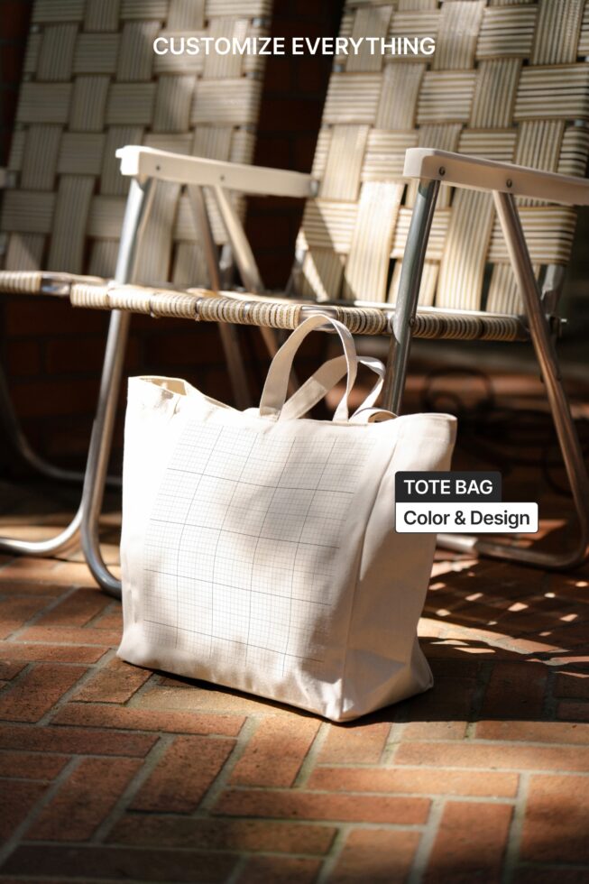 White canvas tote bag sitting on woven chair in sunlit scene