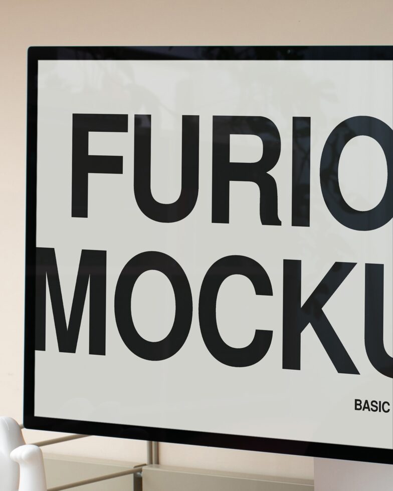 Monitor displaying large black sans-serif typography on white background