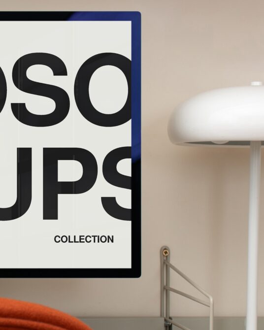 Framed poster with blue border showing large black typography