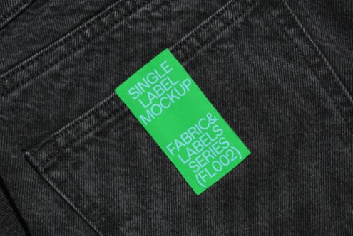 Bright green label on dark denim with white text for Fabric Labels Series