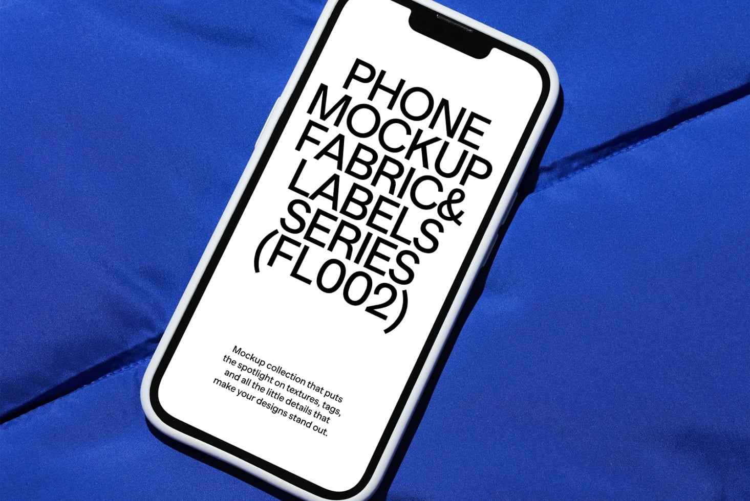 Phone mockup lying on cobalt blue material with visible notch screen