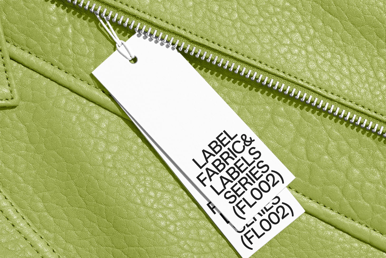 Hang tag mockup on chartreuse leather jacket showing font sizes clearly