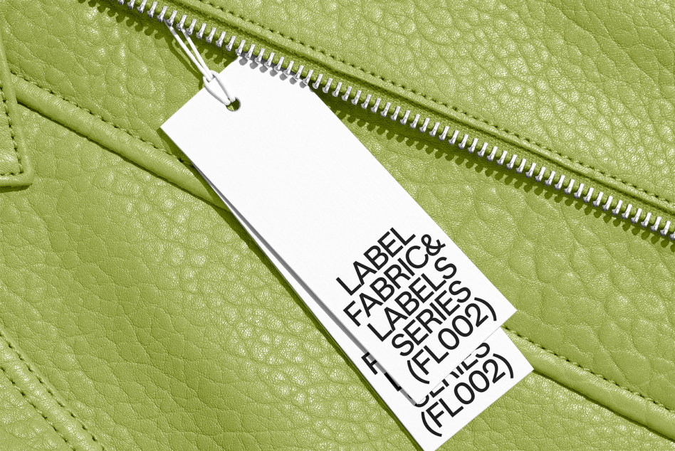 Hang tag mockup on chartreuse leather jacket showing font sizes clearly