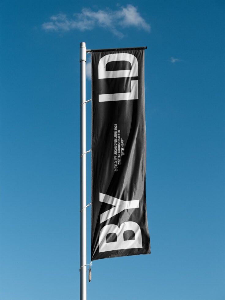 Black horizontal banner flag with white bold letters, mounted on metal pole against blue sky