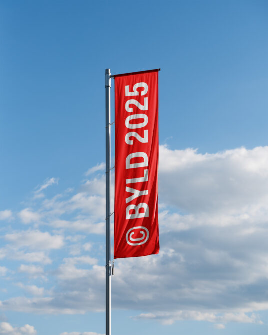 Red vertical banner flag with white numbers, mounted on metal pole against cloudy sky