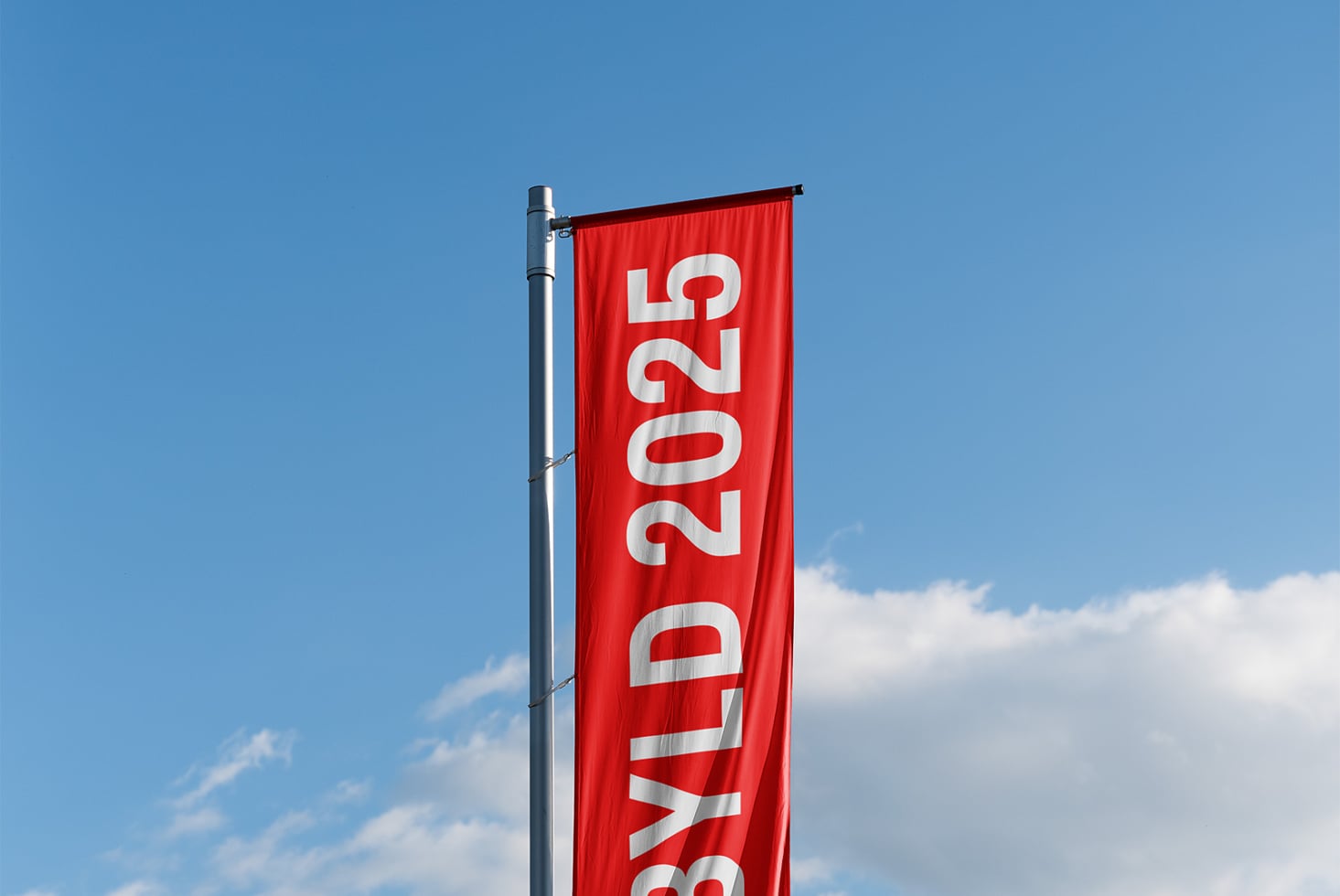 Red horizontal banner flag with white numbers, mounted on metal pole against blue sky