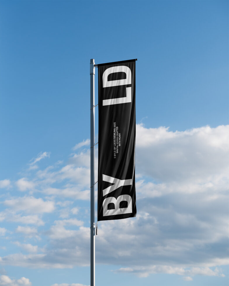 Black vertical banner flag with white bold letters, mounted on metal pole against blue sky