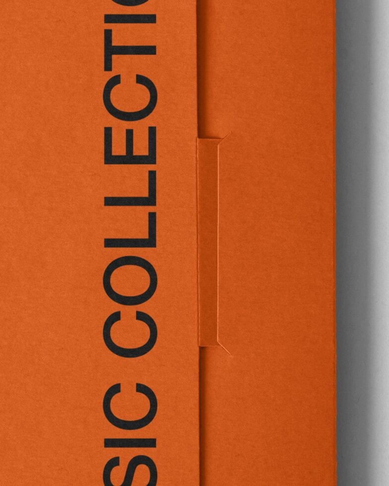 Bright orange folder mockup partially open showing interior fold