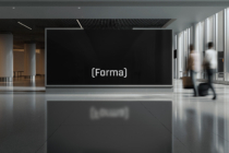 Contemporary gallery space with Forma logo mounted on dark display wall