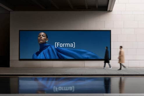 Woman in flowing blue fabric on large transit billboard displaying Forma branding
