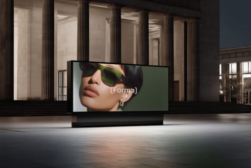 Indoor billboard display showing woman in green sunglasses with brand text overlay