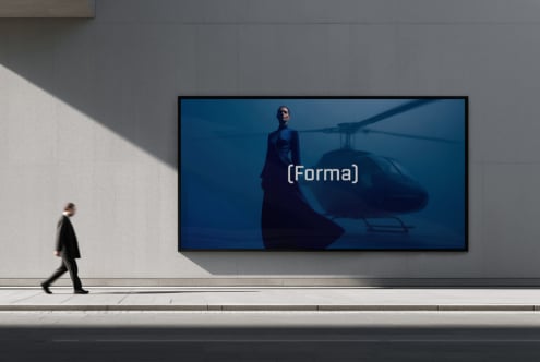 Walking figure passing widescreen display featuring cinematic helicopter scene
