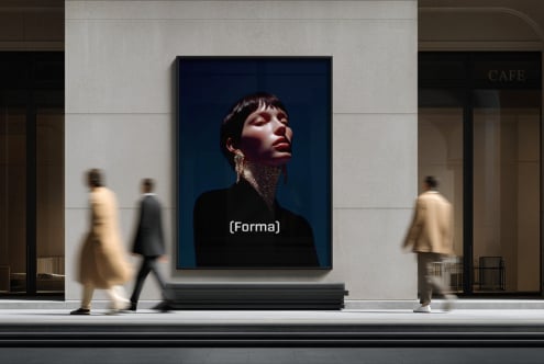 Portrait of person with dramatic lighting displayed on dark blue screen in modern gallery