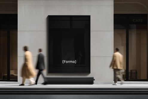 Black display screen mounted on minimal storefront with blurred pedestrians walking by