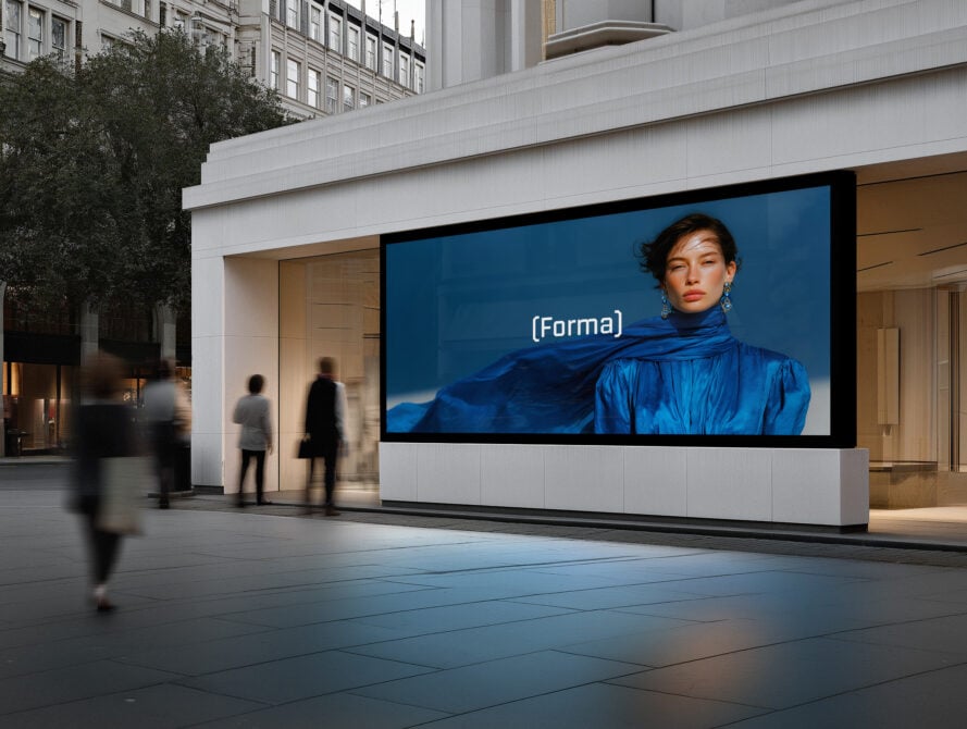 Urban billboard mockup showing woman in blue fabric against deep blue backdrop on storefront