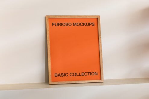 Wooden-framed poster with bright orange mat, black sans-serif lettering
