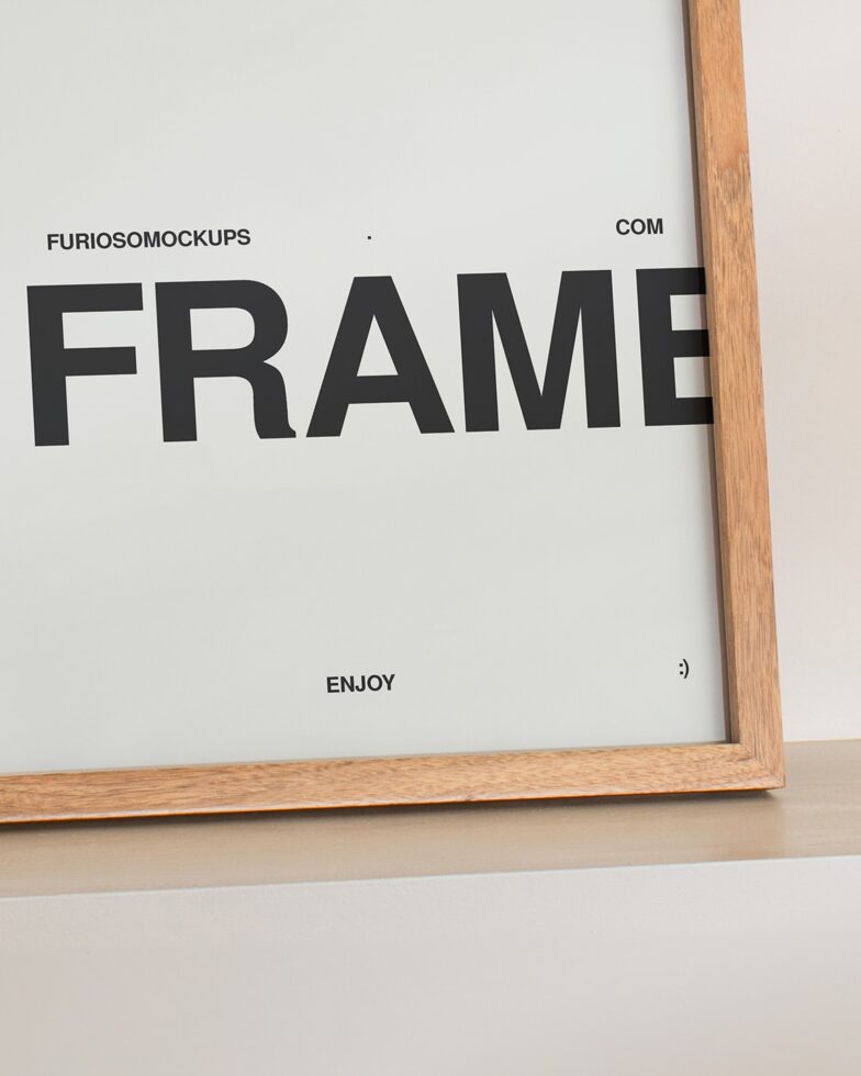 Wooden frame leaning on shelf with white card, black text inside
