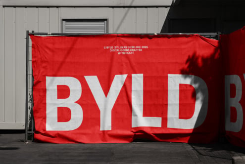 Bright red banner showing BYLD text in white letters on warehouse wall