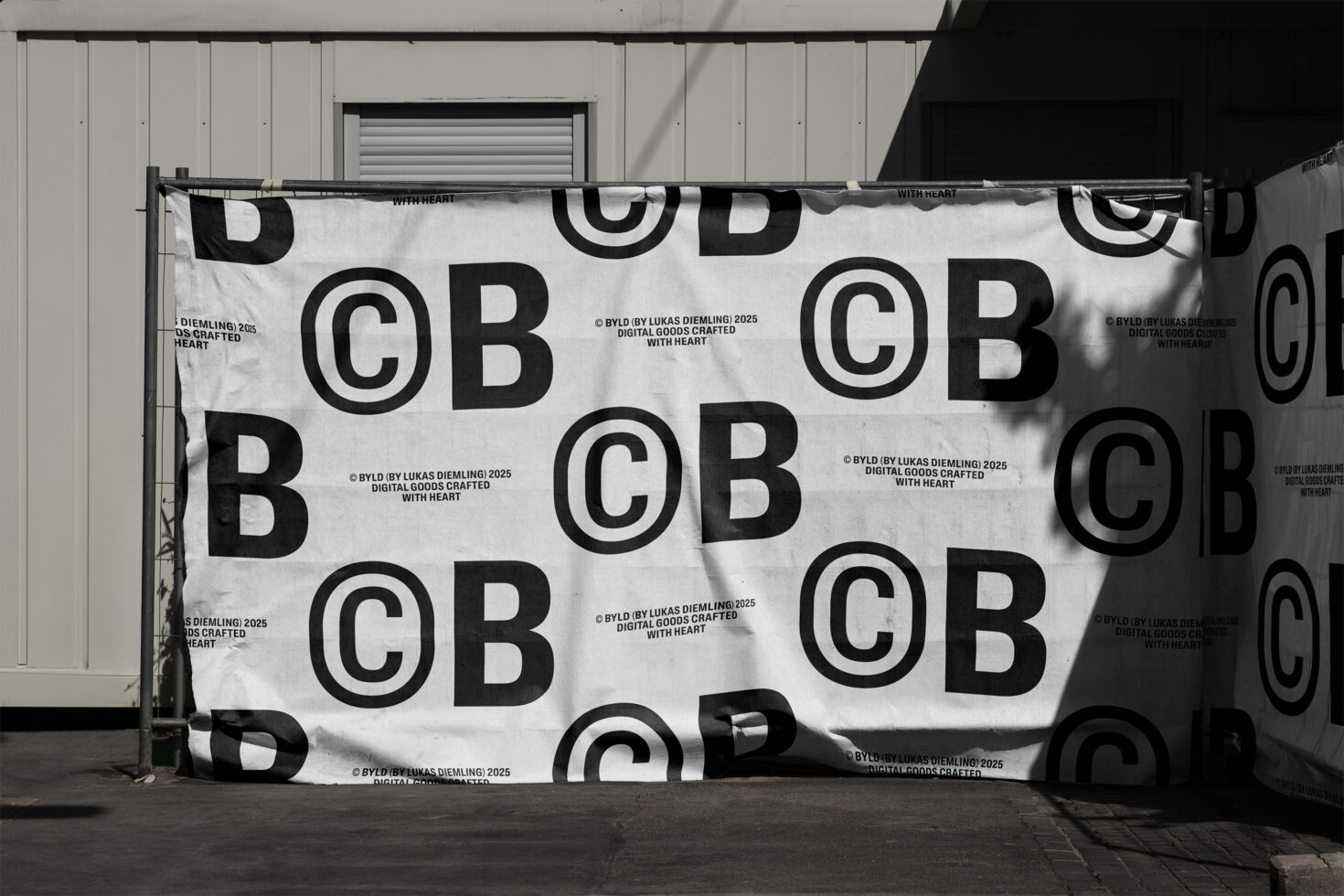 Repeating copyright symbol BYLD pattern on white fabric banner with shadows