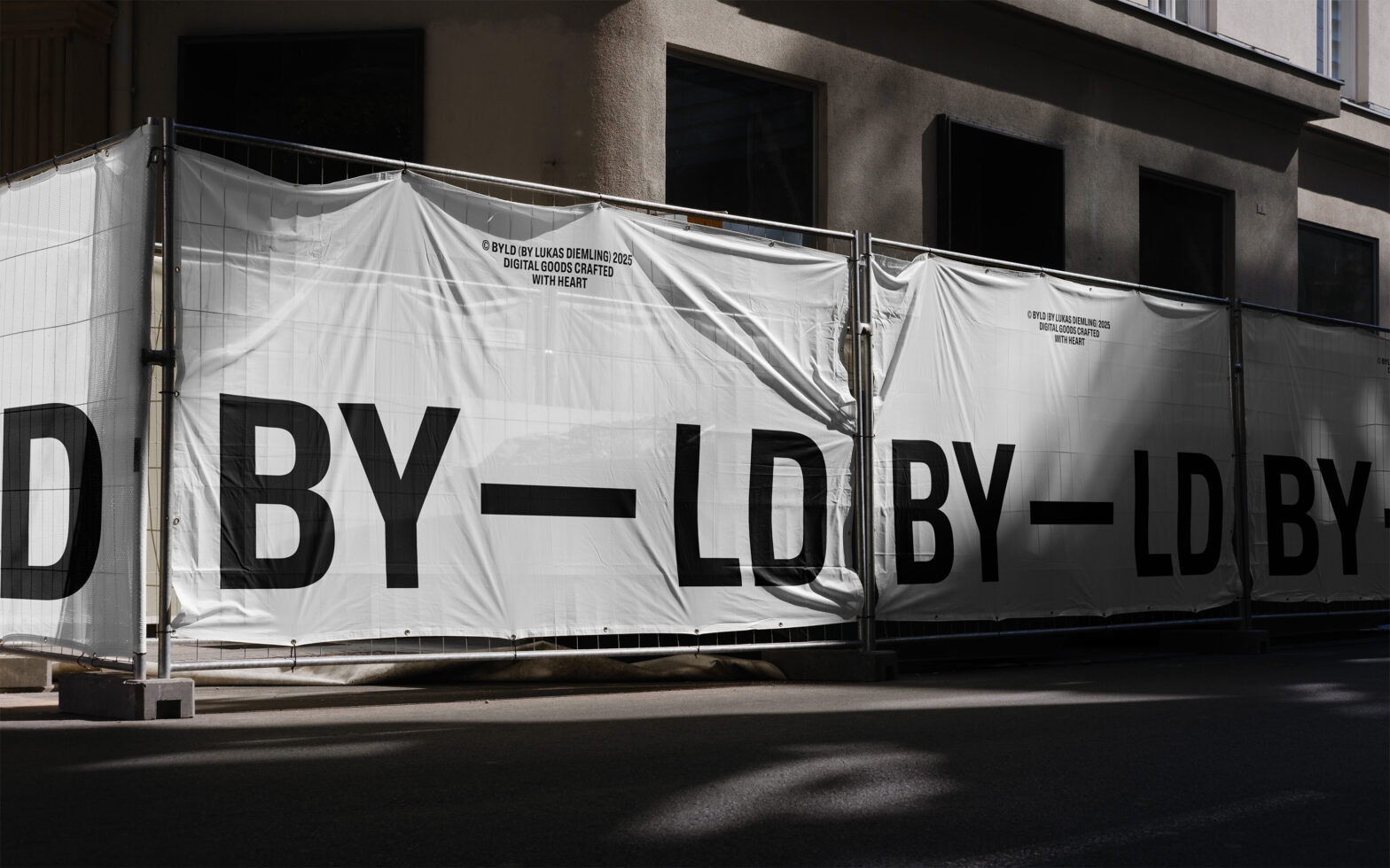 White construction banner with large black BY LD type treatment