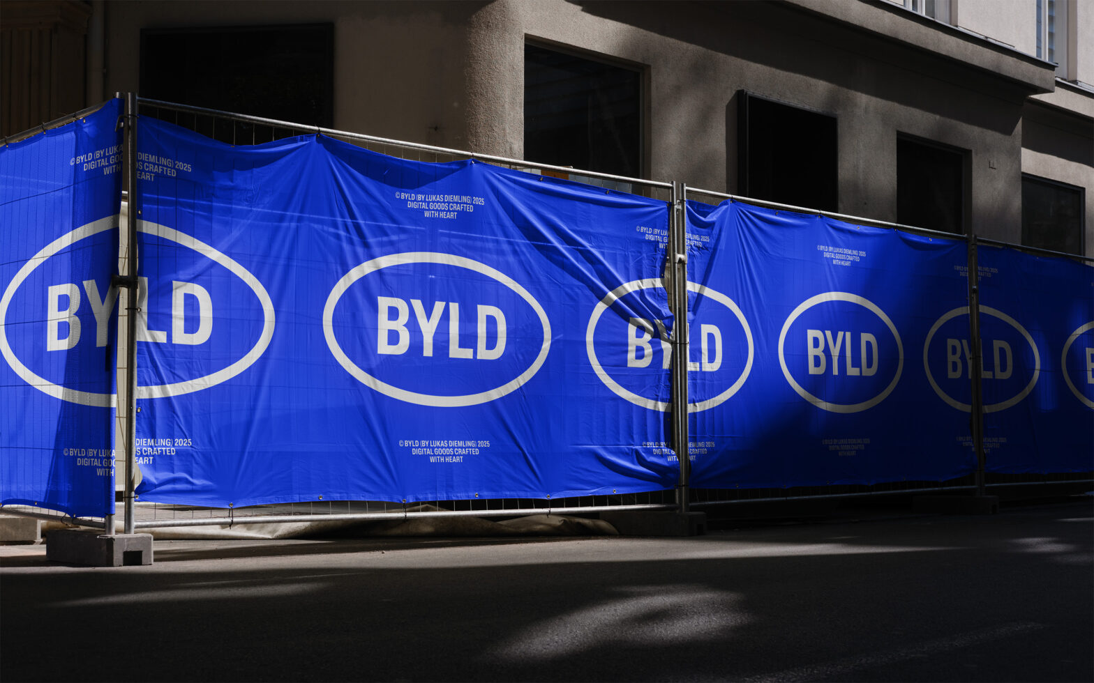 Bright blue construction banner with white BYLD ovals getting smaller across