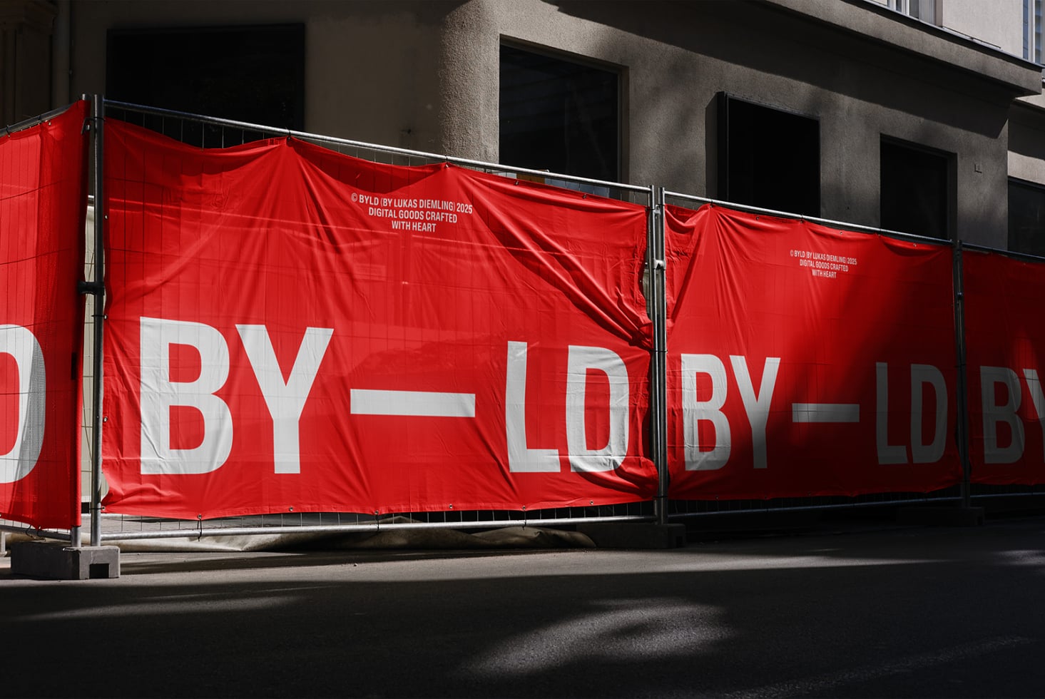 Red construction banner with bold white BY LD text in broken layout