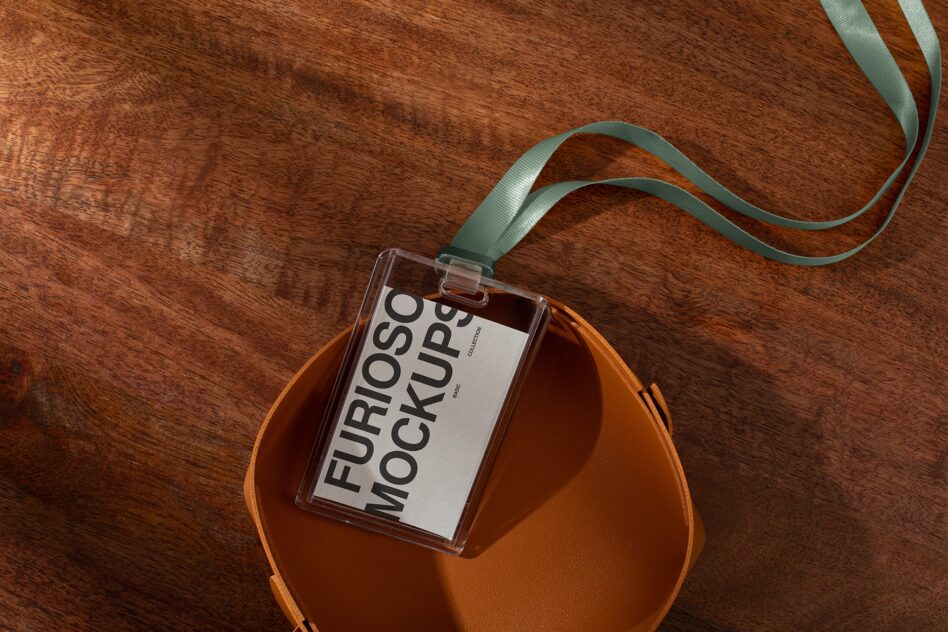 Clear badge mockup with white label on leather pouch with sage ribbon